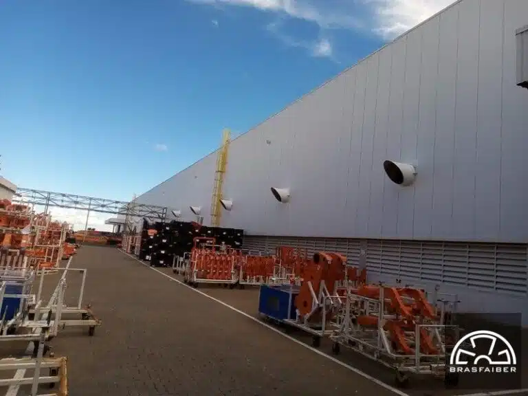 Ventiladores de parede e grelhas de ventilação em galpão industrial